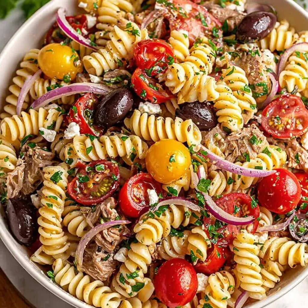 Italian pasta salad: colorful rotini with olives, tomatoes, and Italian dressing.