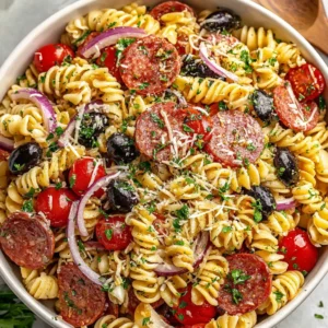 Italian pasta salad: rotini with olives, peppers, cheese and salami.