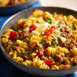 Saucy crockpot taco pasta, a delicious and easy family meal, is shown bubbling in a slow cooker, promising a fiesta of flavor in every bite.