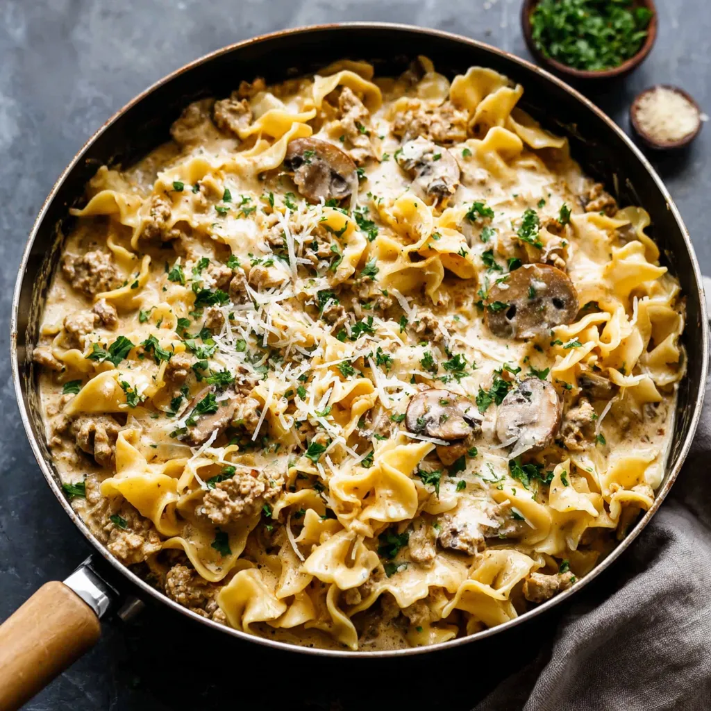 Creamy Turkey Stroganoff Recipe Close-up of creamy Turkey Stroganoff with egg noodles, garnished with fresh parsley.
