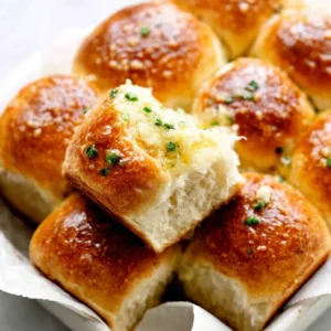 ULTIMATE GARLIC BUTTER BREAD ROLLS 2 Close-up of golden brown Garlic Butter Bread Rolls, perfect for sharing.