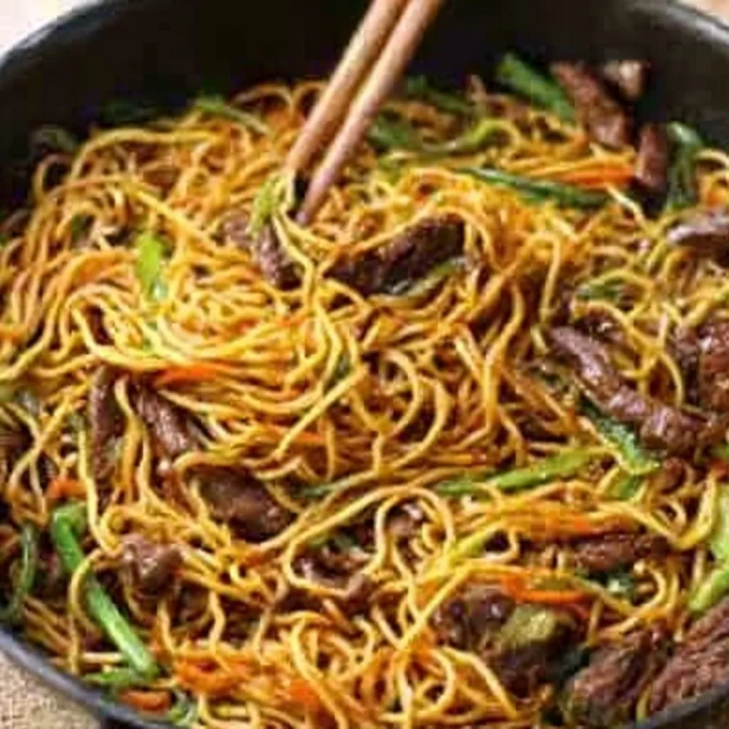 IRRESISTIBLE STICKY BEEF NOODLES 1 Close-up shot of delicious Sticky Beef Noodles, highlighting the glistening sauce and tender beef.