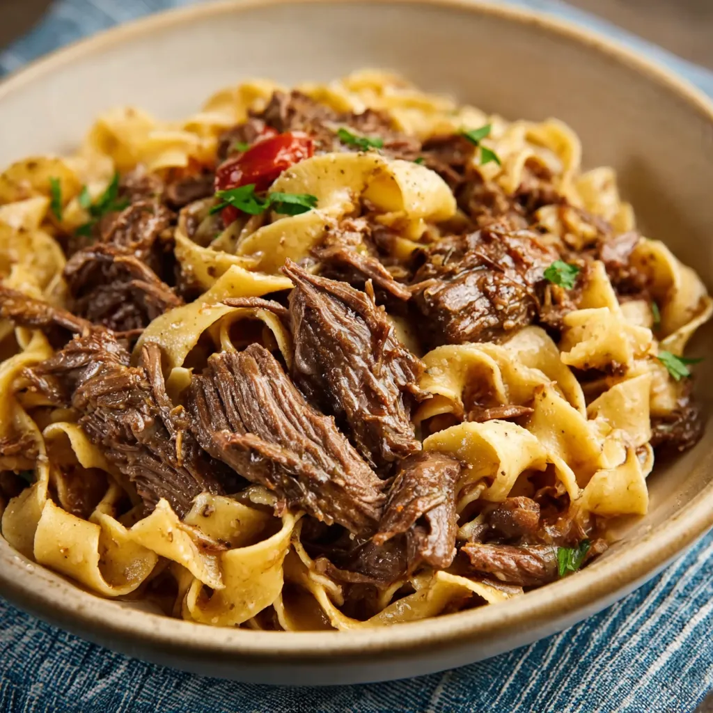 ULTIMATE BEEF AND NOODLES 1 A close-up showcases a delicious bowl of Beef And Noodles, ready to eat.
