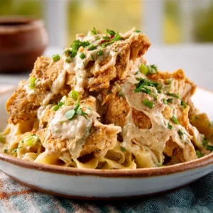 DREAMY MISSISSIPPI CHICKEN WITH CREAM CHEESE 5 A serving of tender, shredded Mississippi Chicken With Cream Cheese in a white bowl, garnished with fresh parsley.